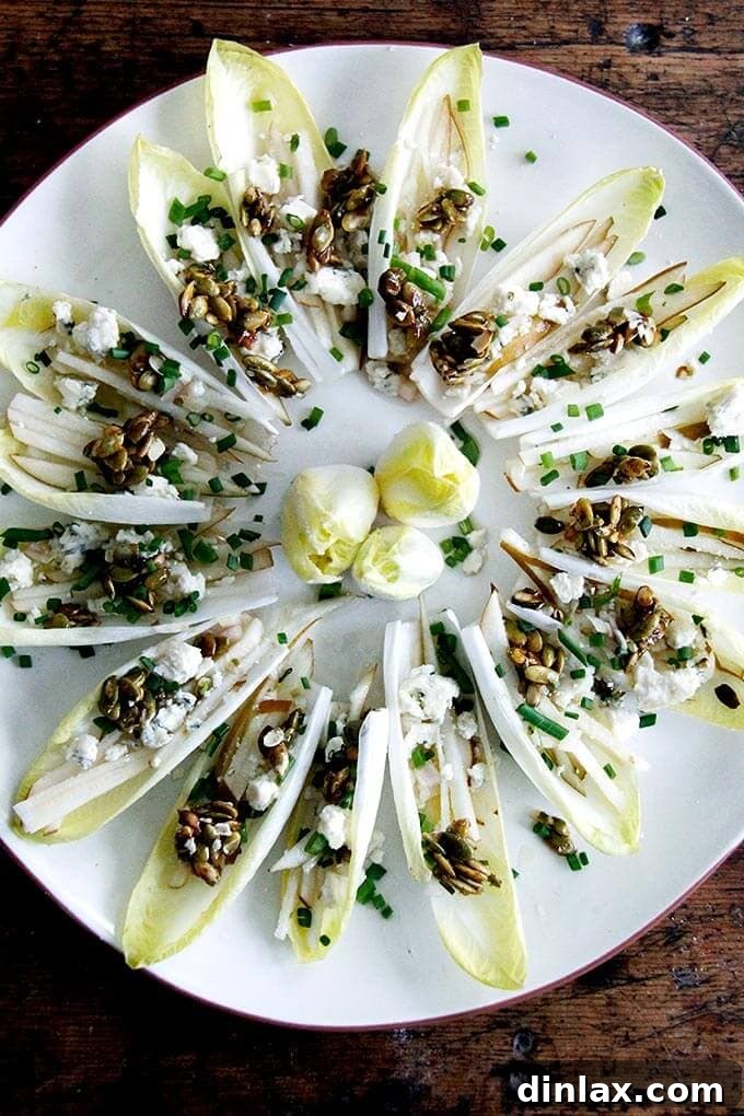 Sparkling Bites: Your Go-To Guide for New Year's Eve Appetizers 3 Fresh Endive Boats with Pear, Blue Cheese, and Candied Pepitas