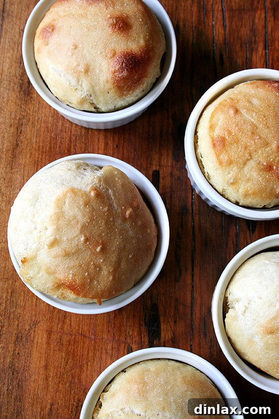 A close-up of several perfectly baked mini bread loaves cooling in their ceramic ramekins, highlighting the soft interior and crispy crust. Ideal accompaniment for a vegan lentil soup. alexandracooks.com