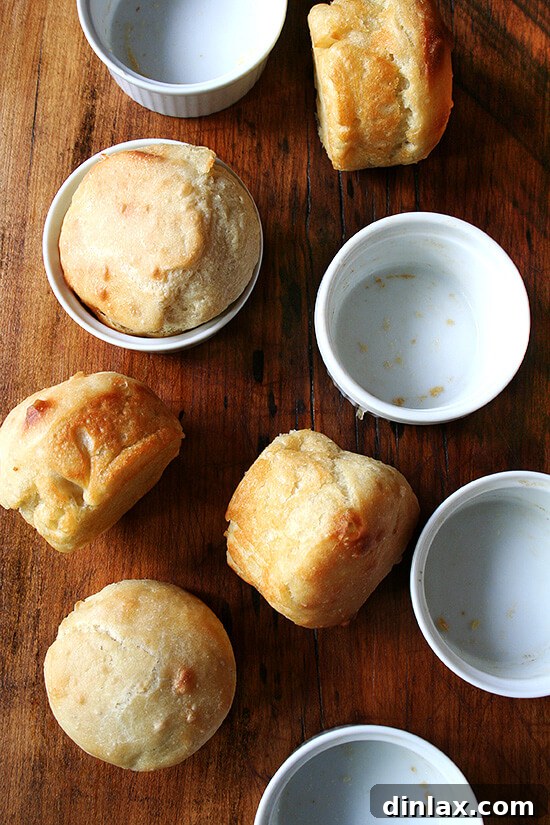 A charming and inviting table setting featuring a warm bowl of vegan lentil soup, a rustic homemade mini bread loaf, and a spoon, emphasizing a healthy, comforting, and complete meal. alexandracooks.com
