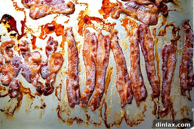 Perfectly crispy oven bacon on a paper towel-lined plate, ready to serve