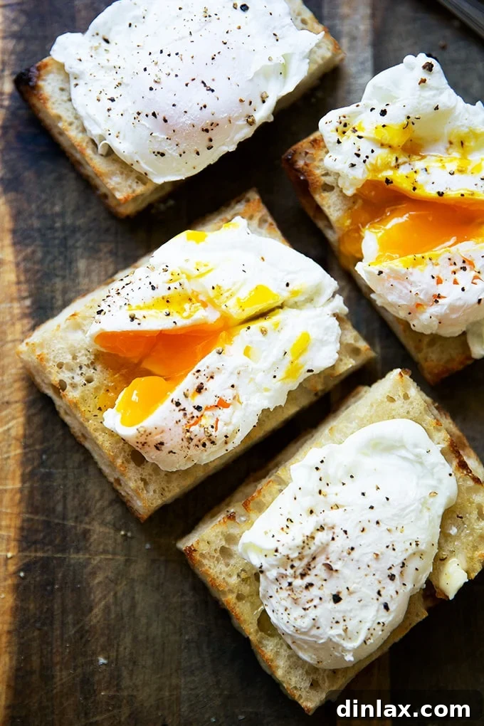 Four golden poached eggs served on crispy toast, a classic and delicious presentation.