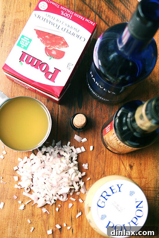 Braised Chicken with Sherry & Sherry Vinegar Ingredients Ingredients for Braised Chicken with Sherry and Sherry Vinegar, including shallots, crushed tomatoes, mustard, sherry, sherry vinegar, and a whole chicken cut into pieces.