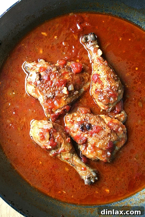 Finished Braised Chicken with Sherry & Sherry Vinegar Close-up of Braised Chicken with Sherry & Sherry Vinegar, showing the tender chicken pieces coated in the rich, glossy sauce, served perhaps with fresh herbs.