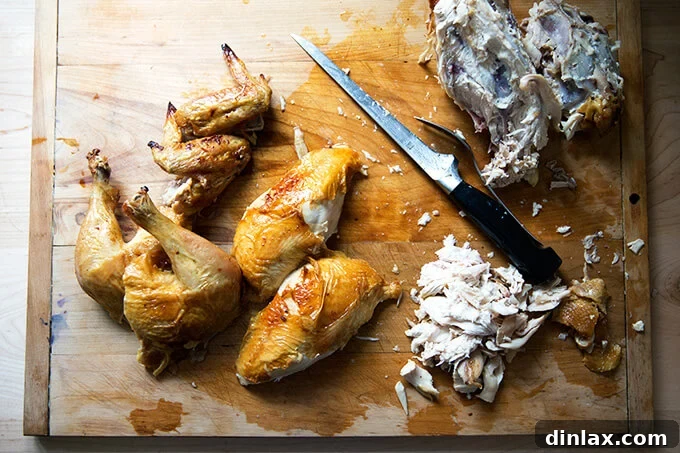 A whole roasted chicken, expertly carved and arranged on a platter.