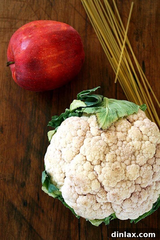 Two bowls of creamy cauliflower and apple soup with fried bread, ready to be served