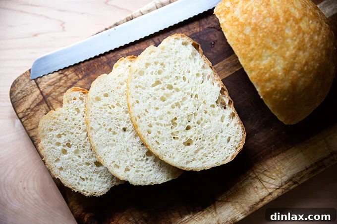 A rustic, round loaf of My Mother's Peasant Bread with a golden-brown crust and a dusting of flour.