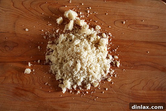Fresh, soft bread crumbs prepared for coating eggs. Close-up of freshly made breadcrumbs, soft and irregular in texture, ready for cooking.