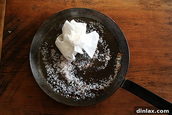 Pan with salt after cleaning A skillet after cleaning with salt, showing the clean surface and a light coating of olive oil for seasoning.