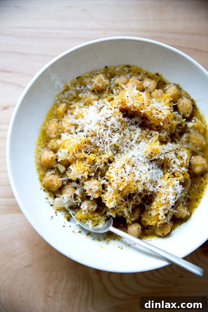 Cacio e Pepe Spaghetti Squash served with savory, garlicky chickpeas, garnished with fresh herbs and more cheese.