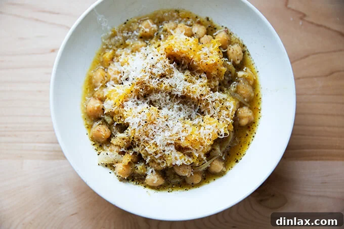 Cacio e Pepe spaghetti squash lovingly piled on top of a bed of stewy, garlicky chickpeas, ready to be enjoyed.