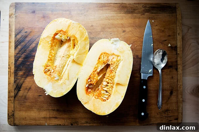 A spaghetti squash halved crosswise, revealing its inner seeds and fibrous core.
