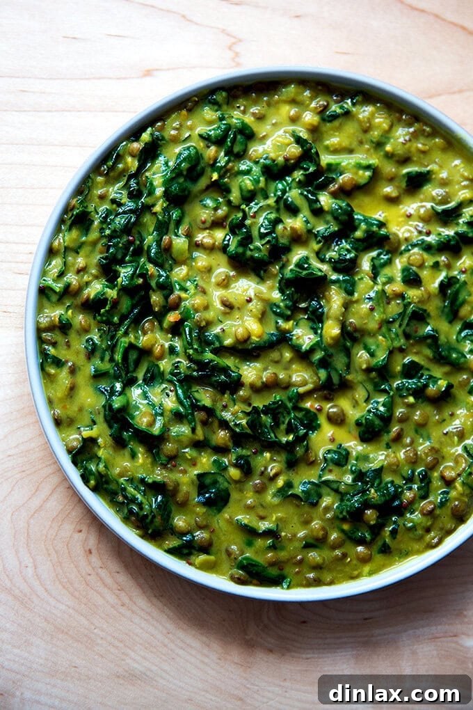 Creamy Coconut Kale Lentil Curry 2 A steaming bowl of vibrant curried lentils with kale and coconut milk, garnished with fresh cilantro, ready to be enjoyed.