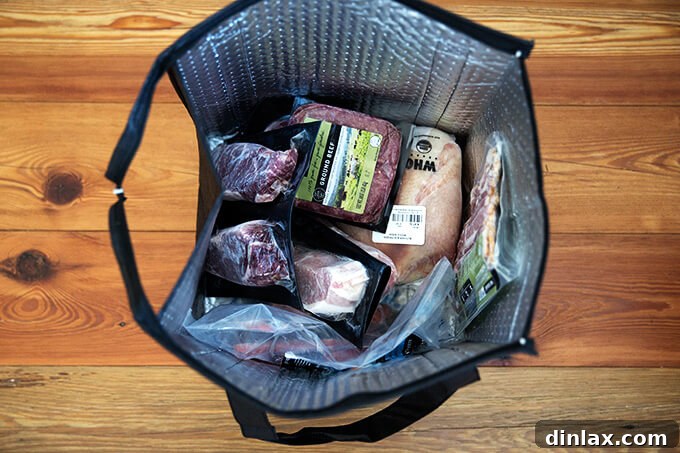 ButcherBox: Ethical Meats Straight to Your Door 7 An open ButcherBox freezer bag revealing various cuts of frozen, individually packaged meats, demonstrating the organized and fresh delivery. Part of the convenient meat delivery service.