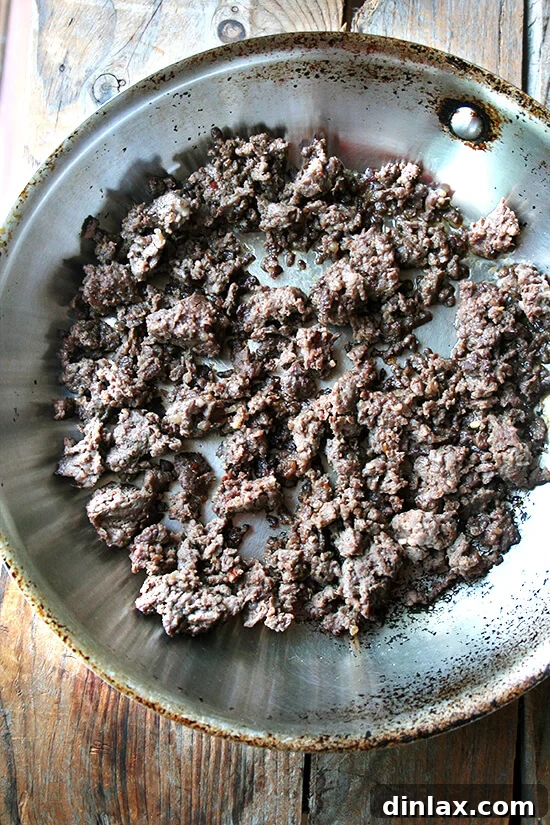 Hearty venison sausage, perfectly browned and ready to be incorporated into the pasta dish, offering a rich, savory addition.