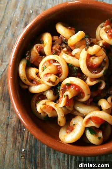 A tantalizing image of Marcella Hazan's white wine and parsley tomato sauce with pasta.