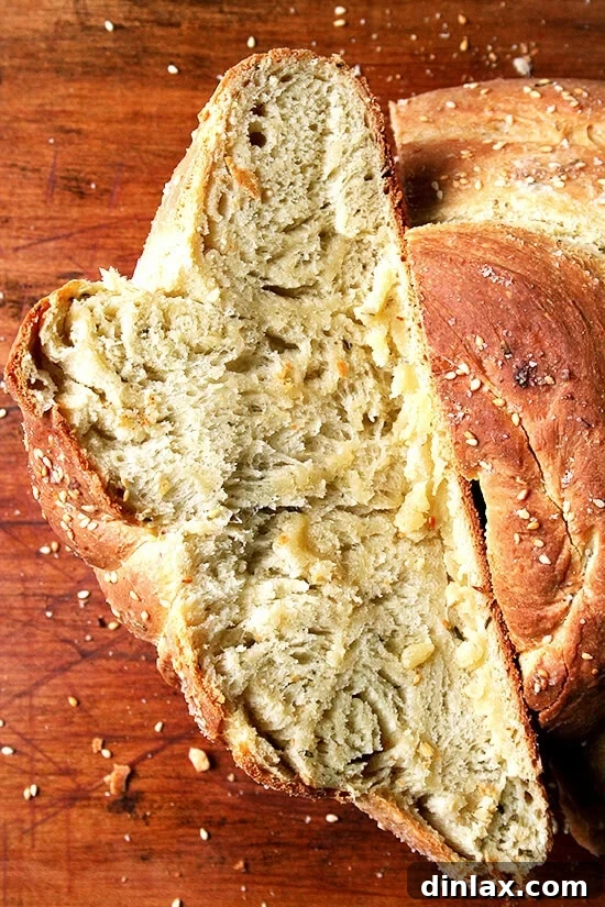 Rosemary Semolina Loaf A close-up view of a freshly baked rosemary semolina loaf, highlighting its appealing crust, perfectly golden color, and the subtle hints of rosemary.