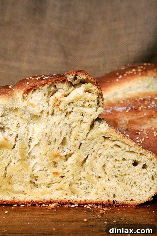 Macrina Bakery-Inspired Rosemary Semolina Bread The finished Rosemary Semolina Bread, golden brown with a salty, crusty exterior, highlights the moist interior provided by olive oil and the unique flavor from semolina flour, a recipe inspired by Macrina Bakery.