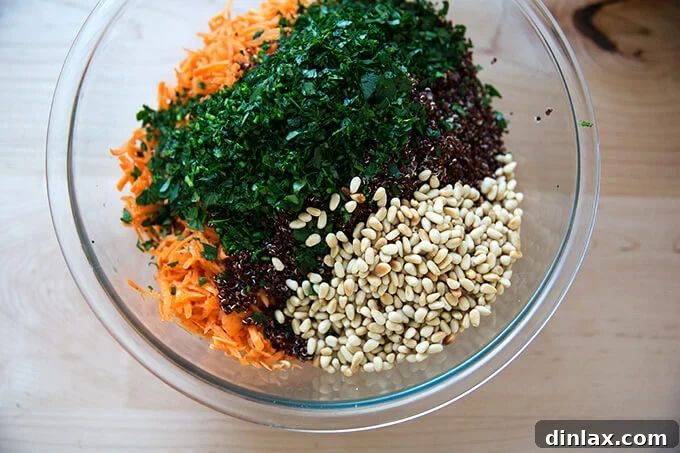 Vibrant Carrot Quinoa Salad with Tangy Tahini Dressing 11 All the salad components — carrots, quinoa, parsley, pine nuts — combined in a bowl