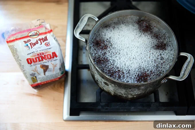 Vibrant Carrot Quinoa Salad with Tangy Tahini Dressing 6 Red quinoa boiling gently in a pot, cooking to perfection