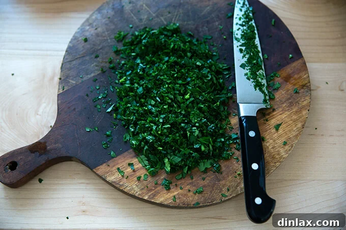Vibrant Carrot Quinoa Salad with Tangy Tahini Dressing 8 Fresh parsley, finely minced and ready for the salad
