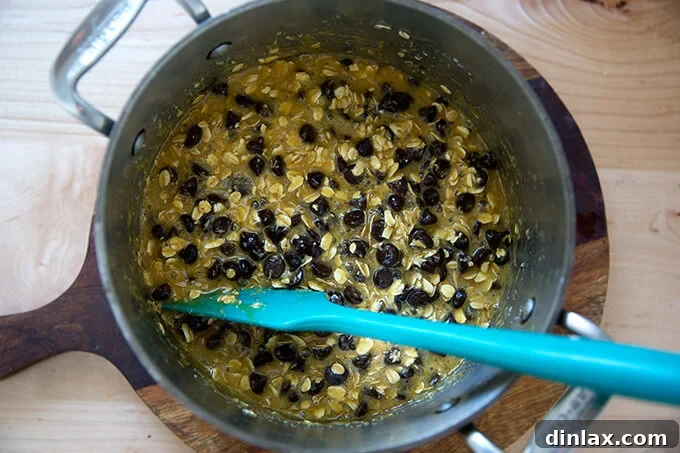 Stirring chocolate chips into the oat bar topping mixture