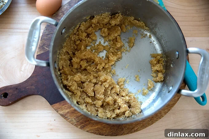 Stirring granulated and brown sugars into brown butter