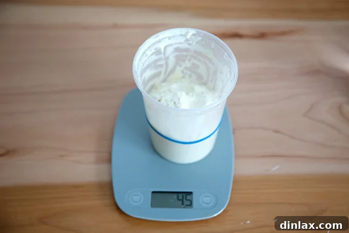 The Easiest Sourdough Focaccia: Perfect for Beginners 3 Adding flour to feed the sourdough starter, a crucial step for activation