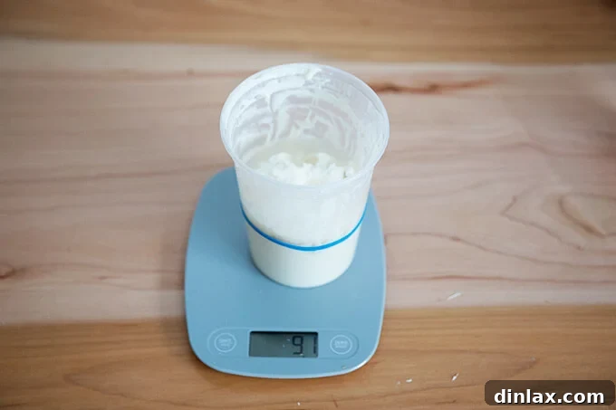 The Easiest Sourdough Focaccia: Perfect for Beginners 4 Adding water to a sourdough starter for feeding, measured accurately