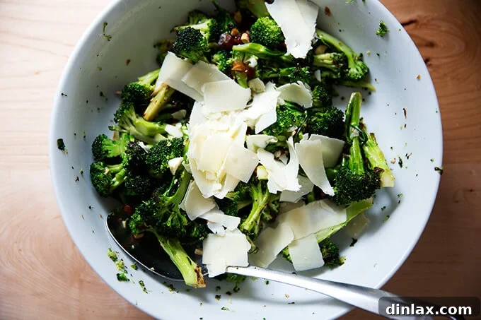 Shaved aged cheddar cheese being added to the broccoli salad.