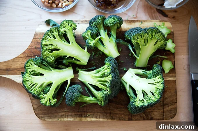 Halved heads of fresh broccoli, ready for searing in a skillet.