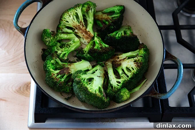 Flipped broccoli heads searing on the floret side for a quick brown.