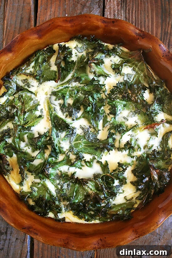 Crustless Kale Quiche: A Healthy and Easy Weeknight Dinner Solution A perfectly baked crustless quiche, generously loaded with vibrant kale, fresh thyme, and a rich, creamy custard, ready for slicing. This image showcases the golden-brown top and the inviting texture of the quiche.