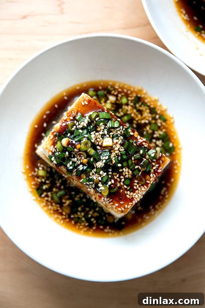 Velvety Tofu with a Garlic Kick 2 A bowl of warm tofu topped with sesame scallion sauce, ready to be enjoyed.