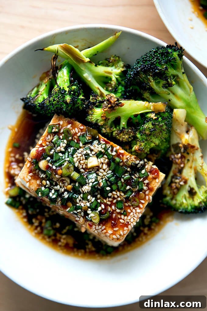 Velvety Tofu with a Garlic Kick 9 A beautifully plated meal of warm tofu with spicy sesame scallion sauce, served alongside spicy broiled broccoli.