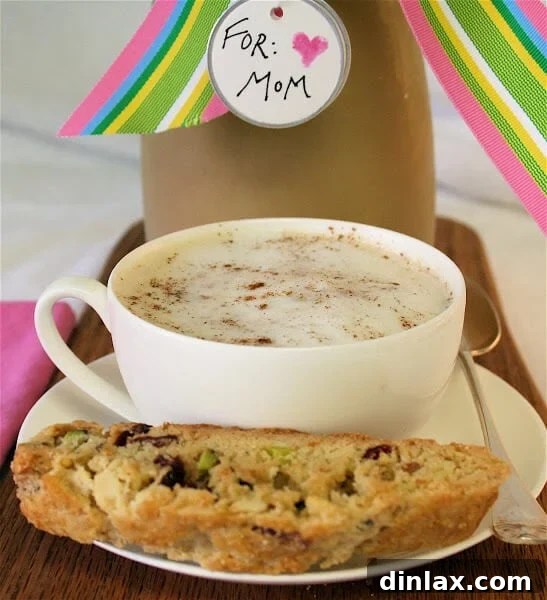 A cup of homemade chai tea, steaming, served alongside a delicious homemade biscotti.