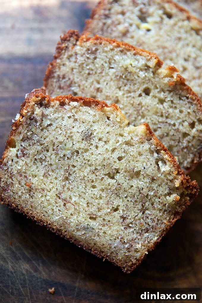 Mrs Myers Legendary Sweet Moist Banana Bread 11 Slices of banana bread neatly arranged on a wooden board, highlighting its tender crumb.