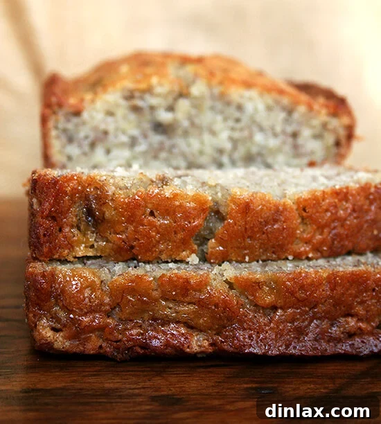 Mrs Myers Legendary Sweet Moist Banana Bread 13 Close-up side view of two slices of moist banana bread on a cutting board, ready to be enjoyed.
