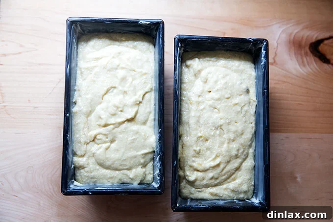 Mrs Myers Legendary Sweet Moist Banana Bread 7 Two loaf pans, each filled with unbaked banana bread batter, ready for the oven.