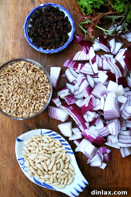Assorted ingredients for preparing farro salad, neatly arranged on a rustic wooden board, ready for cooking.
