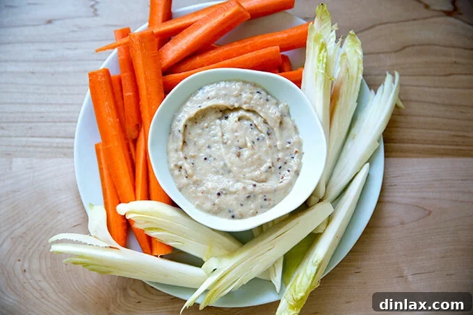 Fresh carrots and endive served alongside a delightful white bean and apple chutney spread