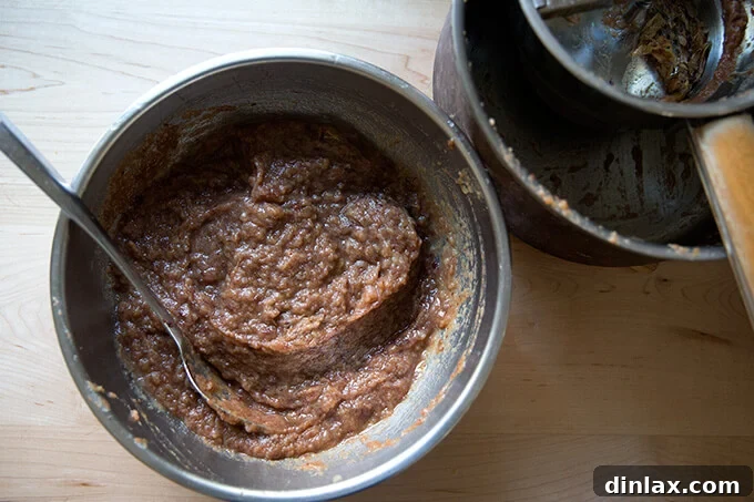 Apple-date mixture being passed through a food mill