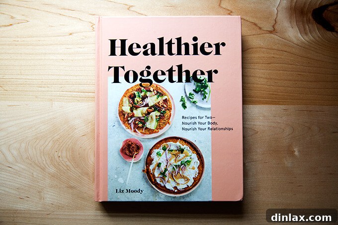 The cover of the 'Healthier Together' cookbook by Liz Moody, featuring an inviting image of wholesome food.