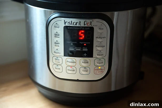 The Instant Pot display showing manual, high pressure, for 5 minutes, which are the optimal settings for perfect hard-boiled eggs.