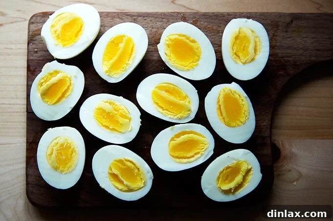Six halved perfect hard-boiled eggs, meticulously made in the Instant Pot, elegantly presented on a plate.