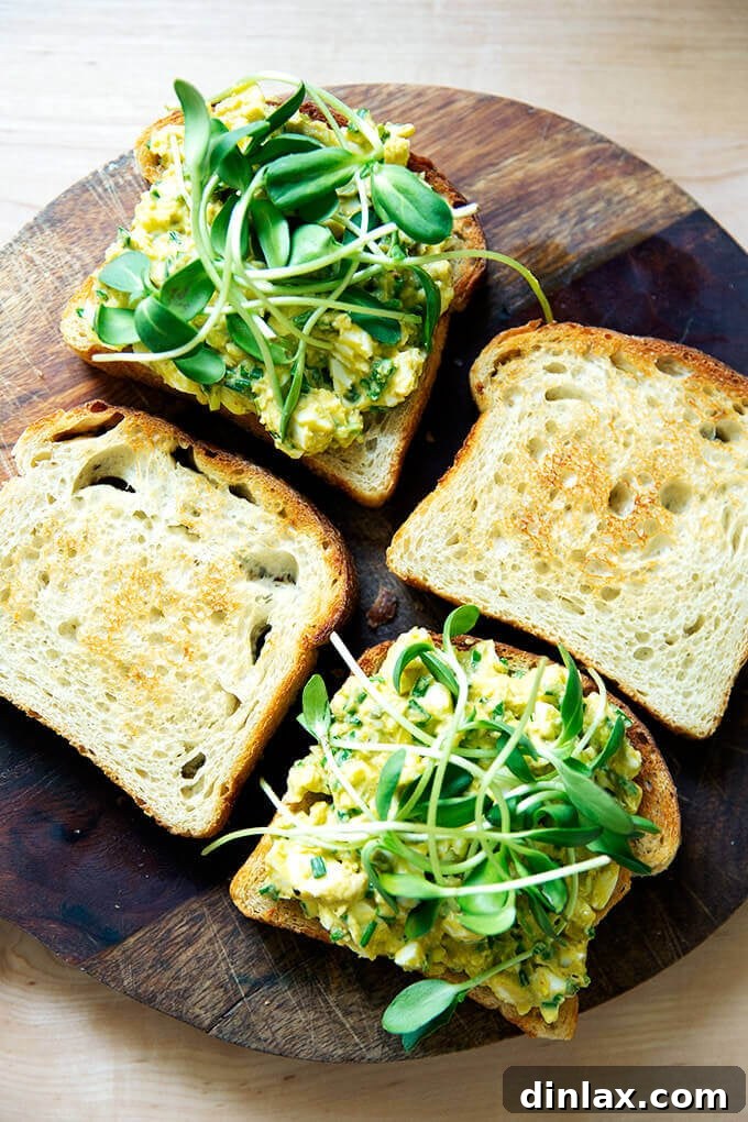 Delicious avocado and egg salad toasts on slices of homemade sourdough bread.