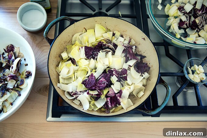 Blistered Chicories, Finished with Chili Heat 5 A sauté pan on the stove with sizzling olive oil, crushed garlic, and the first batch of chopped endive and radicchio.