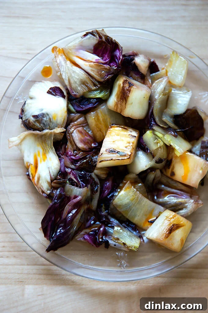 Blistered Chicories, Finished with Chili Heat 9 A close-up shot of a plate of perfectly sautéed chicories with chile oil, highlighting its appetizing texture and vibrant color.