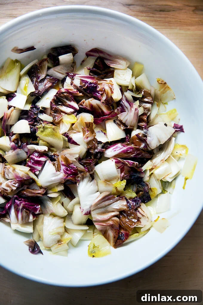 Blistered Chicories, Finished with Chili Heat 10 A rustic bowl filled with golden-brown sautéed chicories, reflecting a healthy and delicious meal.