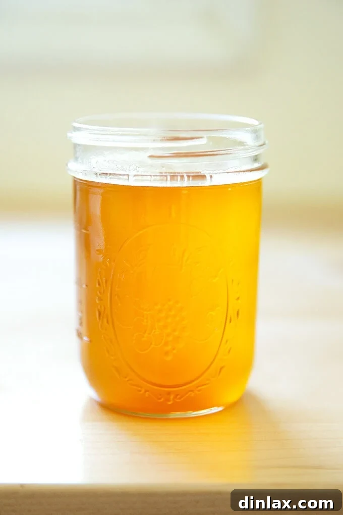 The Art of Ghee Making: A Home Kitchen Guide 2 A jar of freshly made ghee, golden and clear, standing tall. This rich, nutty clarified butter is a cornerstone of Indian cooking and a versatile ingredient for healthy lifestyles. #ghee #clarifiedbutter #paleo #whole30 #indianfood