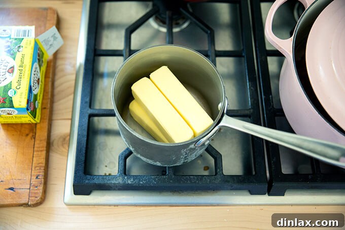 The Art of Ghee Making: A Home Kitchen Guide 4 A small saucepan filled with a pound of unsalted butter, ready to be melted for making ghee.